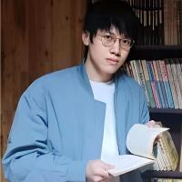 Xiulin Zhang with a book in his hands